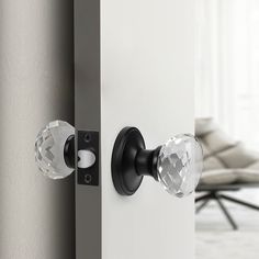 an open door with two crystal knobs on it