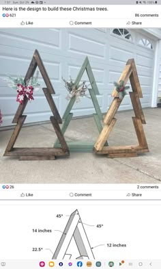 two wooden christmas trees sitting next to each other on top of a cement floor in front of a garage