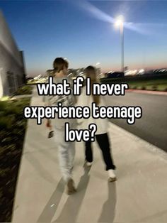 two people walking down a sidewalk with the words what if i never experience teenage love?