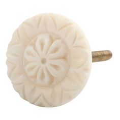 a white knob with a flower design on the front and back of it's head