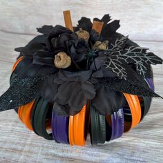 a pumpkin decorated with black and orange ribbons