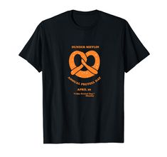 a black t - shirt with an orange and white logo