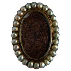 Step into the past with this exquisite antique Victorian mourning brooch, crafted in 14k yellow gold and adorned with natural pearls. This brooch is a poignant reminder of the Victorian era's sentimental jewelry, featuring a unique design that encases a woven hair memento. The lustrous pearls framing the centerpiece add a touch of elegance and reverence. Perfect for collectors and those who appreciate historical jewelry, this piece offers a glimpse into the intimate and personal traditions of th Victorian Hair Locket, Victorian Trinkets, Victorian Hair Jewelry, Easy Lazy Hairstyles, Historic Jewelry, Beach Waves For Short Hair, Sentimental Jewelry, Hair Locket, Elegant Brooch