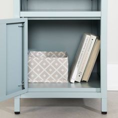 a blue bookcase with books and an envelope