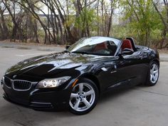 a black bmw z4 convertible parked in a parking lot