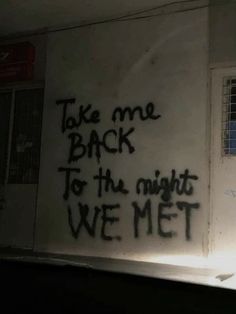 graffiti on the side of a building reads take me back to the night we met