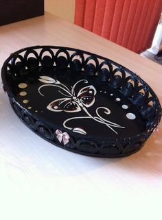 a decorative black tray sitting on top of a table