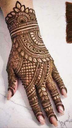 a henna is shown on someone's hand and it has an intricate pattern