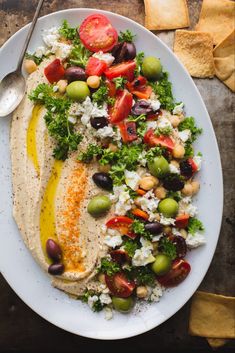 a white plate topped with salad and pita bread