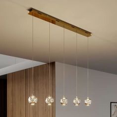 four lights hanging from the ceiling in a room