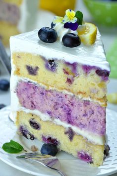 a piece of cake with blueberries and lemon on top