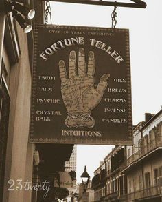 a sign hanging from the side of a building that says fortune teller instructions on it