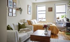 a living room filled with furniture and pictures on the wall