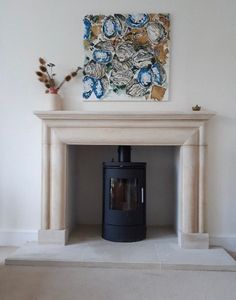 a fireplace with a painting on the wall above it