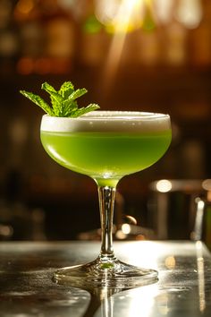 a green drink in a glass on a table