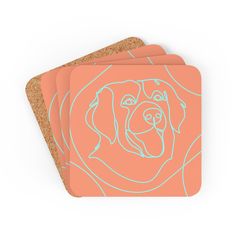 three coasters with a dog's face drawn on them in blue and pink