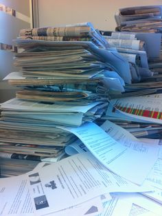 a pile of papers sitting on top of a desk