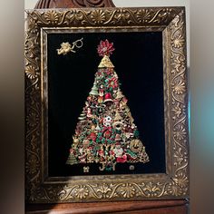 a framed christmas tree with ornaments on it