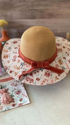 a hat sitting on top of a table next to some sewing needles and other items