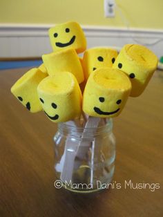 marshmallows in a jar with smiley faces on them