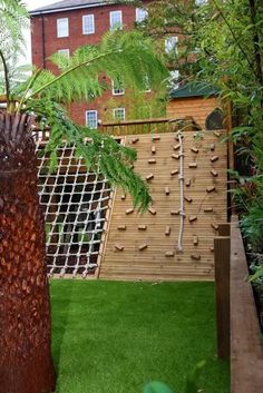 a kids' outdoor play complex with a climbing and rope wall, with a slide and a woven part is a very creative and fun idea to rock Diy Climbing Wall, Wall Climbing, Kids Climbing, Kids Outdoor Play, Sloped Garden