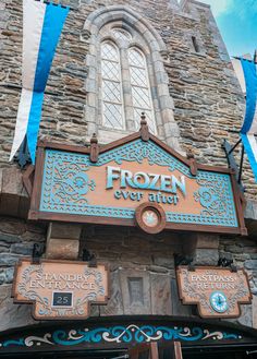 the entrance to frozen ever after is decorated with blue and brown ribbon hanging from it's side