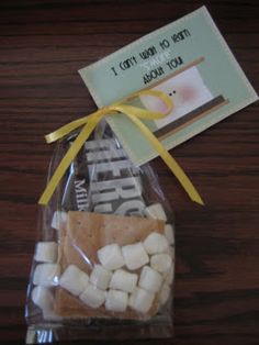 a bag filled with marshmallows sitting on top of a wooden table next to a tag