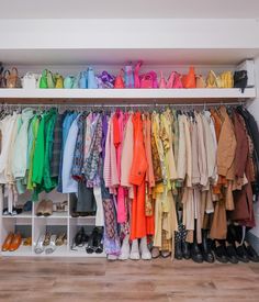 a closet filled with lots of different colored clothes and shoes on shelves next to each other