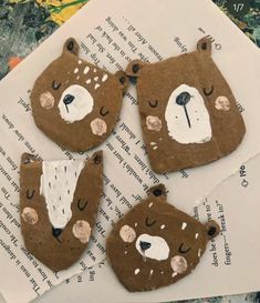 three brown bears made out of paper sitting on top of a piece of paper with holes in it