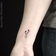 a small tattoo on the wrist of a woman