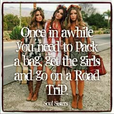 three girls standing next to each other on the road