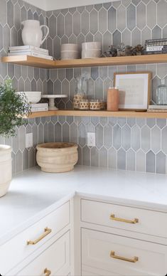 a kitchen with white cabinets and open shelving