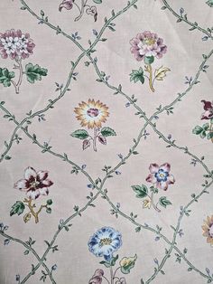 an old wallpaper with flowers and vines on the side, in pastel colors