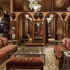 a living room filled with furniture and a chandelier