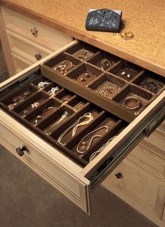 an open drawer with jewelry on it