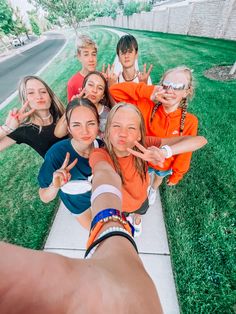 a group of young children standing on top of a sidewalk