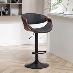 a modern bar stool with black leather upholstered seat and wooden backrests