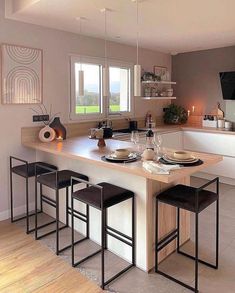 a kitchen with an island and bar stools