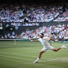 a male tennis player in white is playing tennis on the court and fans are watching