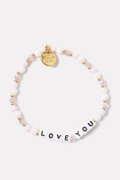 Show some love with this beaded bracelet by Little Words Project, handcrafted with “Love You” lettering, pink and white beads, and stretch elastic for easy on-and-off. Alone or stacked, it makes the perfect gift for yourself or a loved one. Little Words Project encourages you to wear your word to lift you up, and then pass it on to someone who needs it more. Each bracelet comes with a unique ID tag. Use this code to register your bracelet on the Little Words Project website to join the community and track your bracelet’s journey from person to person. | LITTLE WORDS PROJECT Women's Love You Bracelet, Size Small/Medium, Pink Cheap Adjustable Pink Name Bracelet, Valentine's Day Pink Name Bracelet With Letter Beads, Pink Beaded Bracelets With Letter Beads For Valentine's Day, Pink Beaded Bracelet With Letter Beads For Valentine's Day, Adjustable Beaded Bracelets For Valentine's Day, Pink Stretch Bracelet With Letter Beads For Valentine's Day, Valentine's Day Stretch Bracelet With Letter Beads, Valentine's Day Charm Bracelet With Letter Beads, White Letter Beads Friendship Bracelets For Valentine's Day