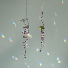 two wind chimes hanging from strings with flowers