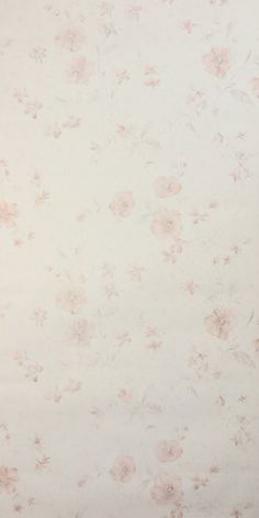 a white and pink flowered wallpaper with small flowers on the bottom half of it