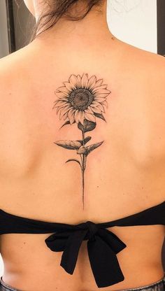 a woman with a sunflower tattoo on her back