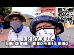 two people wearing masks and hats in front of a disney world sign with the words low crowd - rides, rides, rides