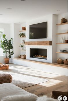 a living room with a fireplace and television on the wall