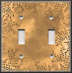 a decorative light switch cover with leaves on it