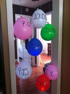 balloons with numbers hanging from the ceiling in front of a door that says $ 500