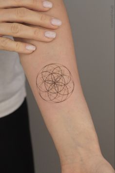 a woman's arm with a small tattoo on the left side of her arm