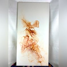 an abstract painting is displayed in a white frame