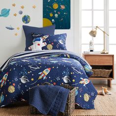 a child's bedroom with space themed bedding